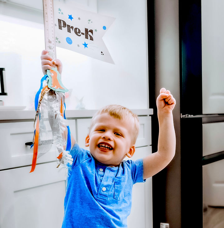 Free Printable First Day of School Signs-boy showing off back to school sign 